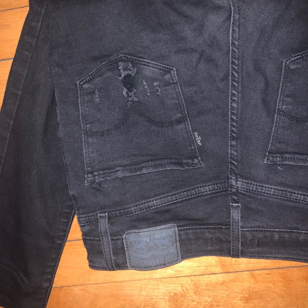 Distressed black Levi’s